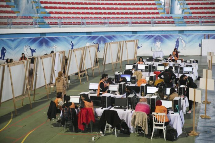 FILE- Members of the Independent Higher Authority for Elections count the votes one day after the parliamentary elections in Tunis, Tunisia, Sunday, Dec. 18, 2022. (AP Photo).