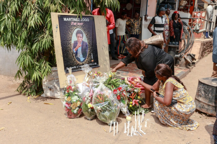 Mourners are seen at a ceremony for killed journalist Martinez Zogo in Yaounde, Cameroon, on January 23, 2023. Police recently arrested new suspects in the investigation into Zogo's death, including businessman Jean-Pierre Amougou Belinga. (Daniel Beloumou Olomo/AFP)