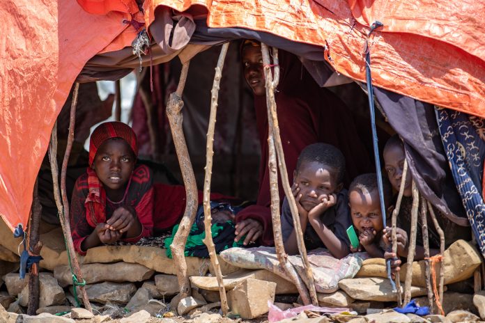 Somali children including girls are seen in Kismayo displacement camp. | UN Photo.