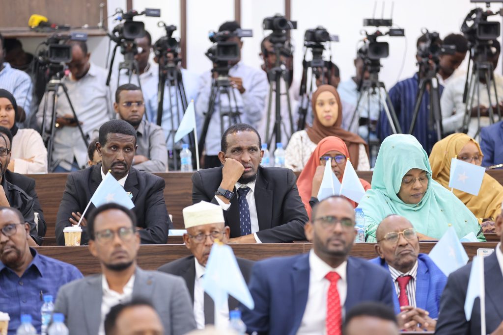 Journalists and their camera equipment are seen on the background during parliamentary session at the Lower House in Mogadishu on 2 January 2024. | Photo/ Official.