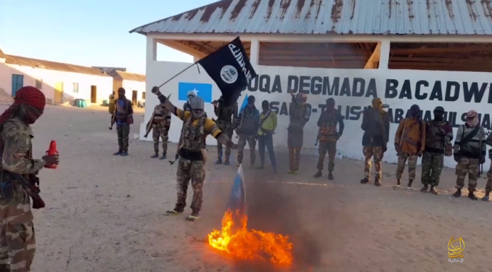 Al-Shabaab fighters burn Somalia national flag after entering Bacaadweyne town in Mudug region on March 14, 2024.