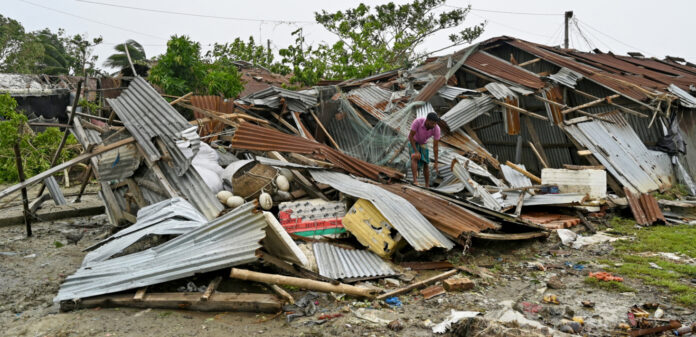 A man inspects his damaged house after cyclone Remal's landfall in Bangladesh and India this week. | AFP/Amnesty.