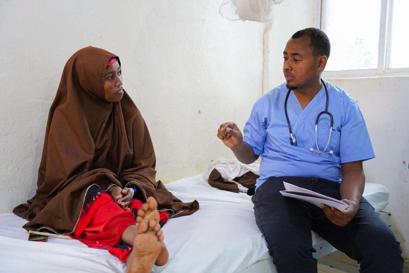 Bay Regional Hospital Medical Director Dr. Abdullahi Yussuf speaks to patient Abaay Haji Nunow, 30.Somalia 2024 © Mohamed Ali Adan/MSF