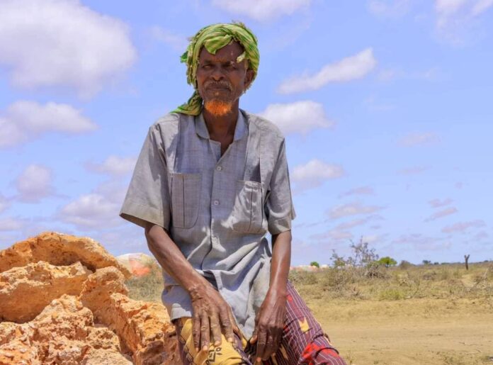 A man is sitting in an open area in Galool Yaryar village, west of Kismayo, Somalia. | PHOTO/ @Cabdalleaxned.