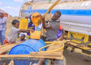 People gather to receive water brought by a local NGO at Galool Yaryar village, west of Kismayo, Somalia.